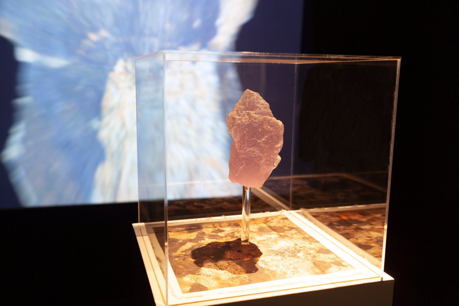 The 3D print in its acrylic case, with the projected animation behind